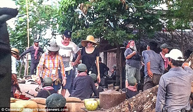 Blending in: The Oscar-winning actress changed into a black outfit as she happily chatted to locals and extras in-between takes